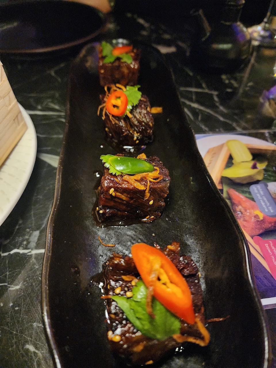 Beef ribs plated with chilli and herbs