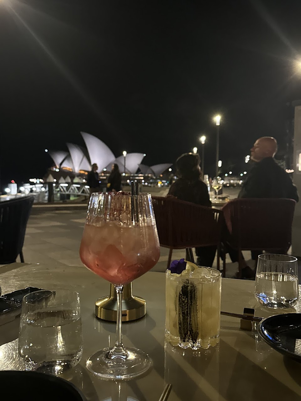 Cocktails on a Luna Lu terrace table facing the Opera House